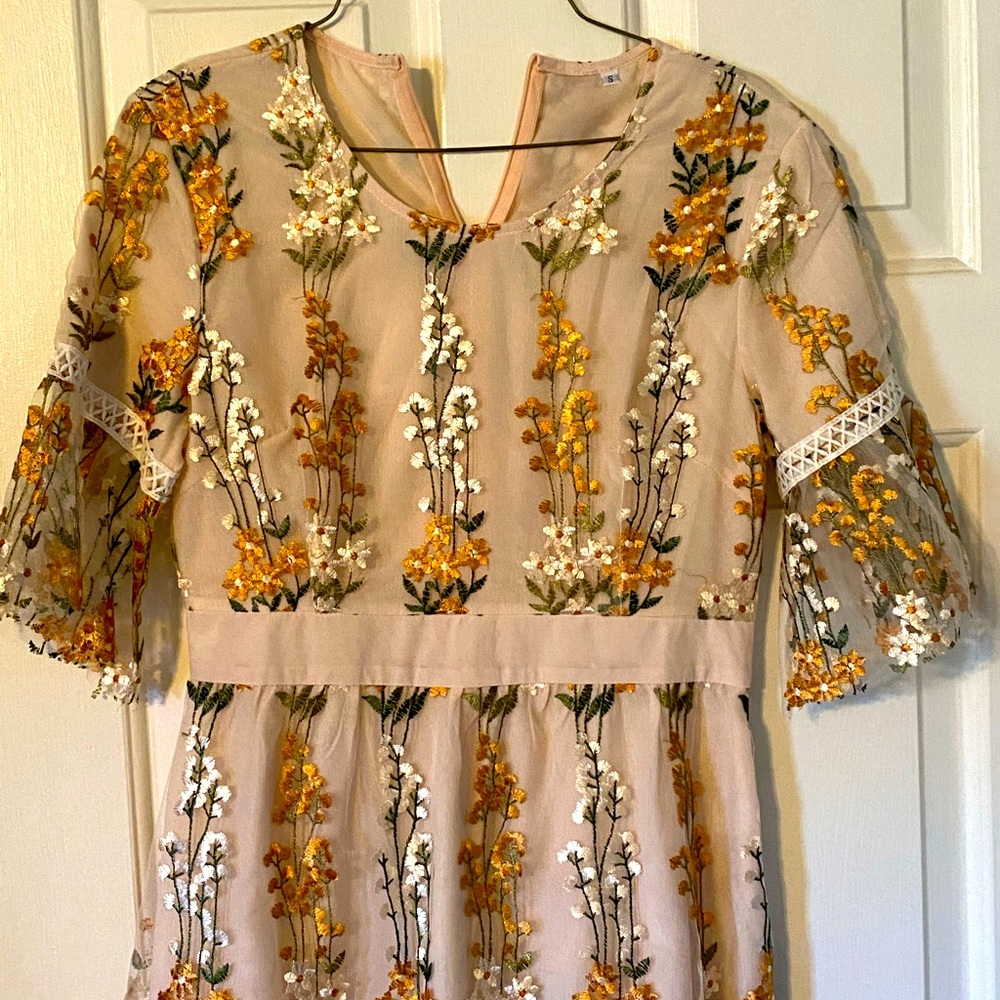 Never worn, size Small. Knee length boutique dress